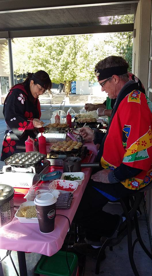 Tomomi Katz on left working at her takoyqki food booth, photo credit Brandy Gannon