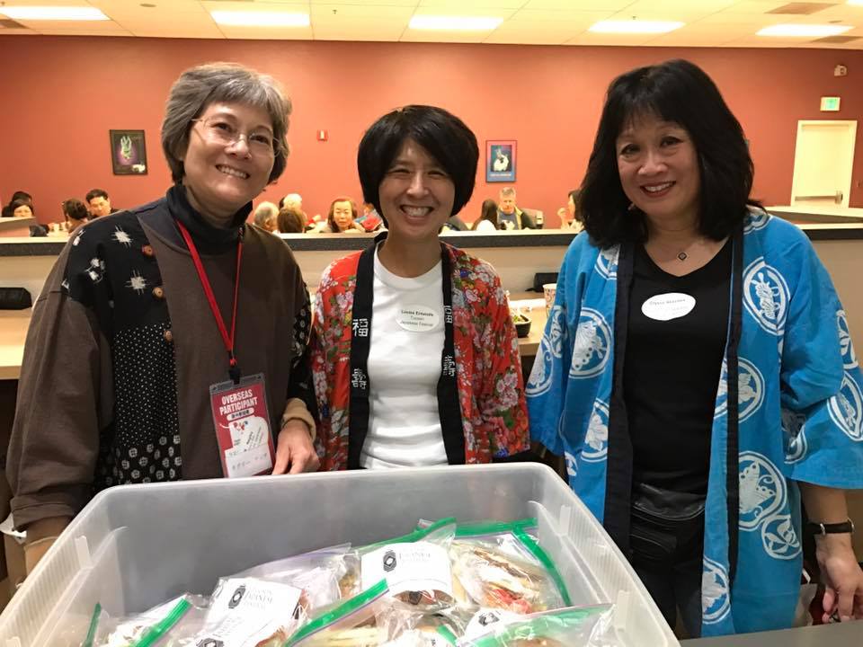 SAJCC Volunteer Coordinator/Secretary K Negley, volunteer Louise Entwhistle, SAJCC graphic designer Crystal Akazawa