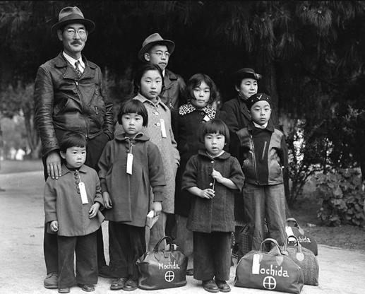 Hayward, California, May 8,1942. Members of the Mochida family awaiting evacuation bus. Photographer: Dorothea Lange