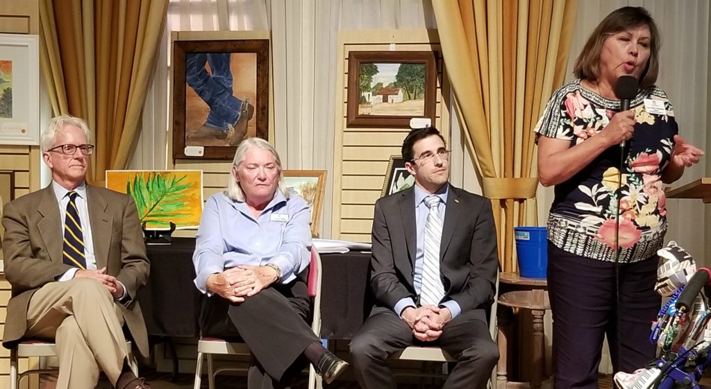 Bruce Wheeler, Barbara Sherry and Matt Heinz listen as Mary Matiella speaks.