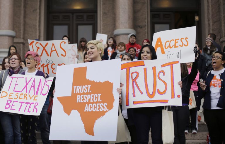 People protest for abortion rights on the steps of the Texas State Capitol building.