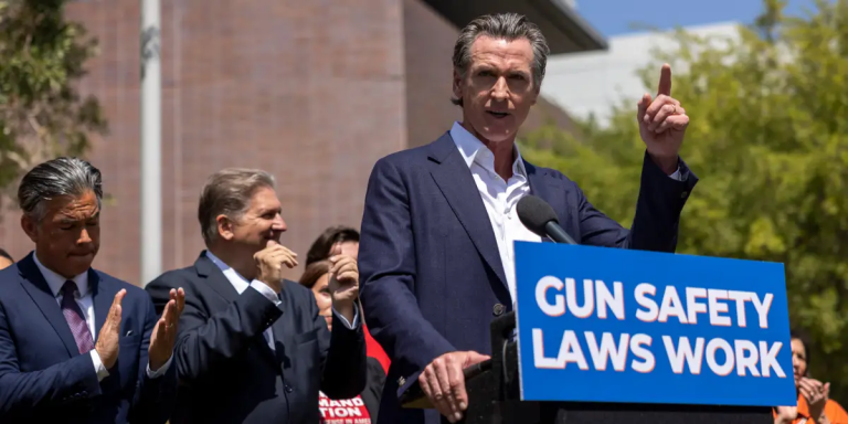 Governor Gavin Newsom stands at a podium